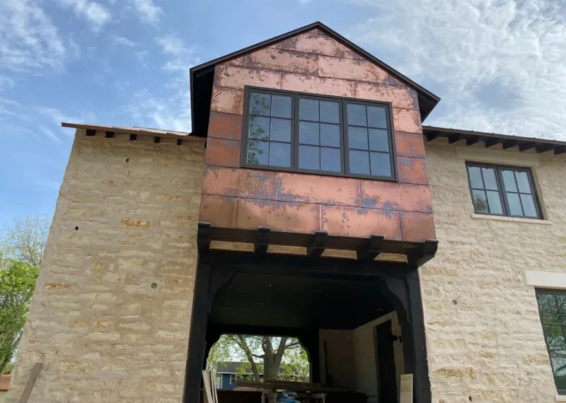 Copper metal panel facade on a stone building for Metal Roof Coating in Coppell